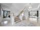 Spacious foyer leads to the living areas, showcasing the staircase and elegant chandelier at 2487 River Tree Cir, Sanford, FL 32771
