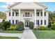 Stately home featuring an elegant entrance with columns, manicured shrubs, and a welcoming walkway at 2487 River Tree Cir, Sanford, FL 32771