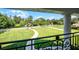 Scenic view of the lush front yard, pond, and landscaping from the home's balcony at 2487 River Tree Cir, Sanford, FL 32771