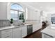 White cabinets, marble countertops, stainless steel appliances, and mosaic backsplash in a bright kitchen at 2487 River Tree Cir, Sanford, FL 32771