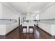Gourmet kitchen boasts custom white cabinetry, granite countertops, and a large center island with seating at 2487 River Tree Cir, Sanford, FL 32771