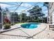 Enclosed pool with brick paver patio and screen surrounding with trees in the background providing extra privacy at 2487 River Tree Cir, Sanford, FL 32771