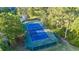 Aerial image of community tennis court showing the well-maintained blue and green surface surrounded by lush greenery at 2487 River Tree Cir, Sanford, FL 32771