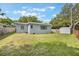 Beautiful backyard with green grass and mature trees creating a serene outdoor space at 2603 E Marks St, Orlando, FL 32803
