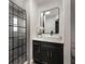 Modern bathroom featuring a sleek vanity, stylish mirror, and glass-enclosed shower at 2603 E Marks St, Orlando, FL 32803