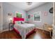 Cozy bedroom filled with natural light, featuring hardwood floors and stylish accent furniture at 2603 E Marks St, Orlando, FL 32803
