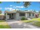 Charming one-story home featuring a brick driveway, covered parking and freshly painted exterior at 2603 E Marks St, Orlando, FL 32803
