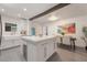 Modern kitchen boasts an island with a farmhouse sink, stainless steel wine cooler and an adjacent dining area at 2603 E Marks St, Orlando, FL 32803