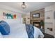 Cozy main bedroom with a decorative fireplace, TV, and comfortable bedding at 2603 E Marks St, Orlando, FL 32803