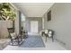 Inviting outdoor patio with rocking chairs and bench seating in a cozy space at 2603 E Marks St, Orlando, FL 32803
