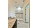 Bright bathroom featuring granite countertop vanity and luxurious walk-in shower with marble-style tile at 2645 Sw 155Th Ln, Ocala, FL 34473
