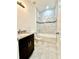 Bathroom featuring modern white and gray tiling in the shower and backsplash over the vanity at 2645 Sw 155Th Ln, Ocala, FL 34473