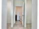 Hallway view into a modern bathroom featuring dark cabinets and tile flooring at 2645 Sw 155Th Ln, Ocala, FL 34473