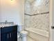 Stylish bathroom with granite vanity, sleek toilet, and a modern bathtub with a tiled surround at 2645 Sw 155Th Ln, Ocala, FL 34473