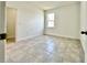 Spacious bedroom with neutral tile flooring, a window for natural light, and a fresh, modern aesthetic at 2645 Sw 155Th Ln, Ocala, FL 34473