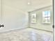 Bright, tile floored bedroom with two windows allowing plenty of natural light at 2645 Sw 155Th Ln, Ocala, FL 34473