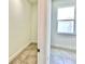 Hallway view showcasing an attached walk-in closet and a brightly lit room with a window at 2645 Sw 155Th Ln, Ocala, FL 34473