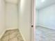 Hallway view showcasing an attached walk-in closet and a brightly lit room at 2645 Sw 155Th Ln, Ocala, FL 34473
