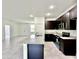 Open kitchen with dark wood cabinets, granite counters, and stainless steel appliances at 2645 Sw 155Th Ln, Ocala, FL 34473