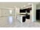 Open-concept kitchen boasts dark cabinetry, granite countertops, and a center island with stainless steel appliances at 2645 Sw 155Th Ln, Ocala, FL 34473