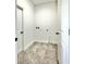Compact laundry room with tile flooring, utility connections, and a bright, clean ambiance at 2645 Sw 155Th Ln, Ocala, FL 34473
