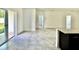 Open concept living area featuring neutral tile floors and sliding glass doors leading to the patio at 2645 Sw 155Th Ln, Ocala, FL 34473