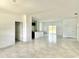Open-concept living room featuring tile floors, bright lighting, and access to the kitchen and backyard at 2645 Sw 155Th Ln, Ocala, FL 34473