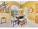 Sunny breakfast nook featuring a modern table set, natural lighting, and wood floors at 283 Lakay Pl, Longwood, FL 32779