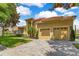 Mediterranean-style home with a two-car garage, paved driveway, and well-manicured lawn under a partly cloudy sky at 283 Lakay Pl, Longwood, FL 32779