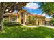 Two-story home showcasing manicured lawn, three-car garage, and lush landscaping at 283 Lakay Pl, Longwood, FL 32779