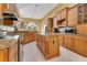 Open kitchen featuring wood cabinets, granite countertops and a center island with bar seating at 283 Lakay Pl, Longwood, FL 32779