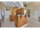 A bright, open kitchen featuring granite counters, a center island and stainless refrigerator at 283 Lakay Pl, Longwood, FL 32779