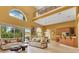 Bright, open-concept living room with high ceilings, large windows, and comfortable seating at 283 Lakay Pl, Longwood, FL 32779