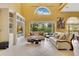 Inviting living room featuring built-in shelving, large windows, and neutral-toned furniture at 283 Lakay Pl, Longwood, FL 32779