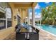 Outdoor patio area with dining table, seating, and a refreshing pool view at 283 Lakay Pl, Longwood, FL 32779