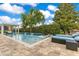 Backyard pool featuring inground lounge chairs, waterfall features, and manicured landscaping at 283 Lakay Pl, Longwood, FL 32779