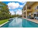 Backyard pool featuring elegant landscaping and a covered balcony at 283 Lakay Pl, Longwood, FL 32779