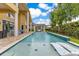 Backyard swimming pool with in-pool loungers, covered pergola, and outdoor seating at 283 Lakay Pl, Longwood, FL 32779