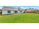 Spacious backyard features a well manicured lawn and solar panels at 3038 Golden Rock Dr, Orlando, FL 32818