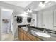 Bathroom featuring double sinks with granite countertop and wood cabinetry at 3038 Golden Rock Dr, Orlando, FL 32818