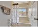 Bright bathroom with a tiled tub-shower and white cabinets at 3038 Golden Rock Dr, Orlando, FL 32818