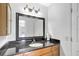 Bathroom features a vanity with granite countertop, undermount sink, framed mirror, and lighting fixture at 3038 Golden Rock Dr, Orlando, FL 32818