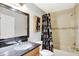 Bright bathroom features a granite countertop vanity, large mirror, and shower-tub combo with a unique Paris-themed curtain at 3038 Golden Rock Dr, Orlando, FL 32818