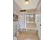 Bright bathroom with a tiled tub-shower and white cabinets at 3038 Golden Rock Dr, Orlando, FL 32818