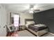 Well-lit bedroom with hardwood floors, fan, comfortable bed, and stylish decor at 3038 Golden Rock Dr, Orlando, FL 32818