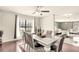 Formal dining area with elegant table, seating, hardwood flooring, and ample natural light at 3038 Golden Rock Dr, Orlando, FL 32818