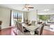 Dining room with decorative light fixture, large window, and hardwood flooring at 3038 Golden Rock Dr, Orlando, FL 32818