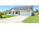 Lovely home with a wide driveway, two car garage, and manicured front lawn at 3038 Golden Rock Dr, Orlando, FL 32818