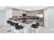 Open kitchen with a large bar, stainless steel appliances, and stylish counter seating at 3038 Golden Rock Dr, Orlando, FL 32818