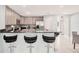 Modern kitchen with sleek black countertops, stainless steel appliances, and stylish bar seating at 3038 Golden Rock Dr, Orlando, FL 32818